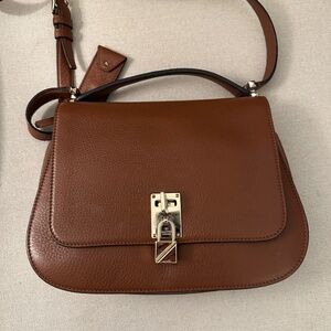 Valentino Garavavini Pebbled calfskin Joylock flap messenger bag.